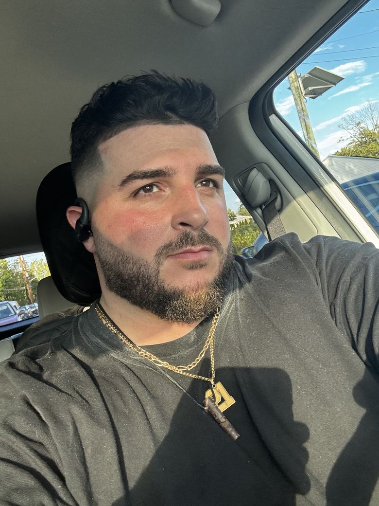 Portrait of Gemini in a black tee and gold chains